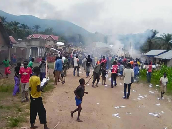 Crowds gathered in the street in the aftermath of the raid in Boga, Democratic Republic of Congo, in which more than 200 people were abducted